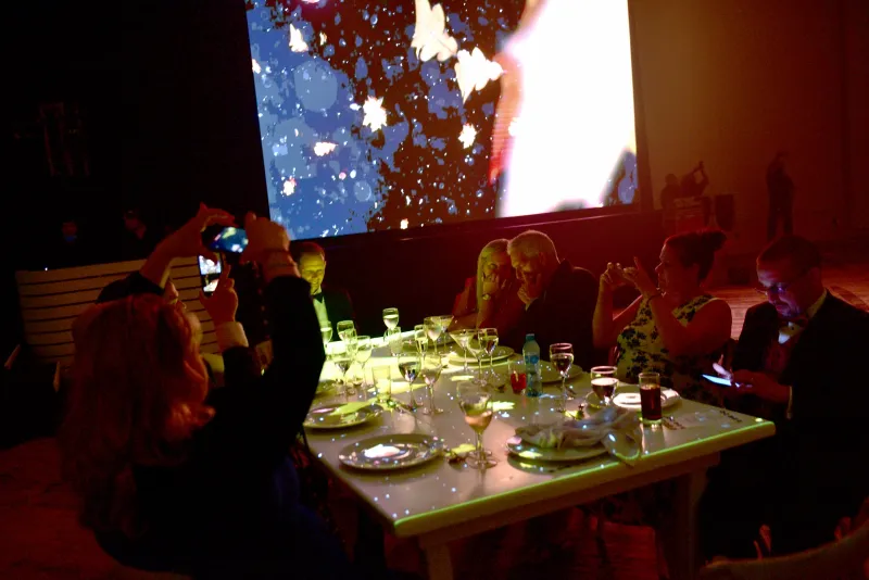 Attendees seated together taking photos