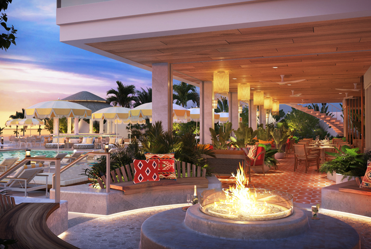 outdoor seating area with fireplace at sunset