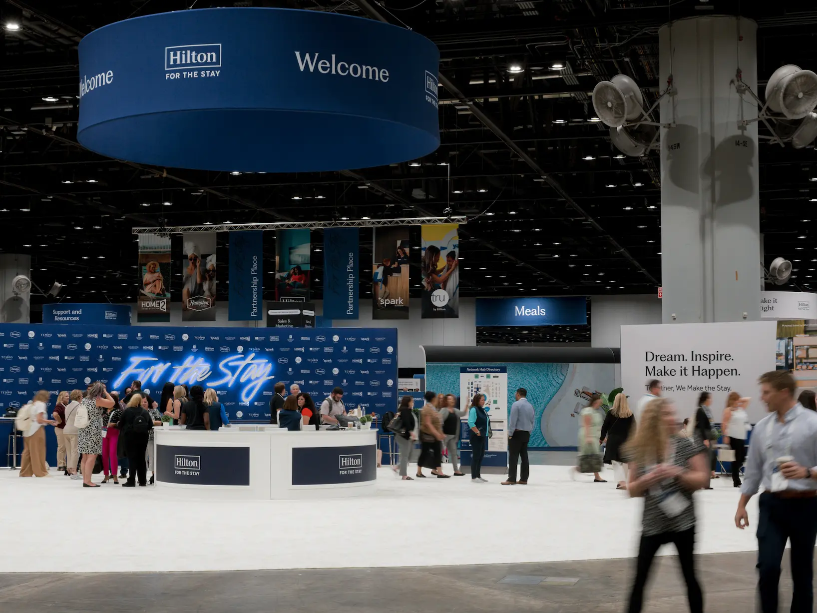 people gathering near a welcome desk