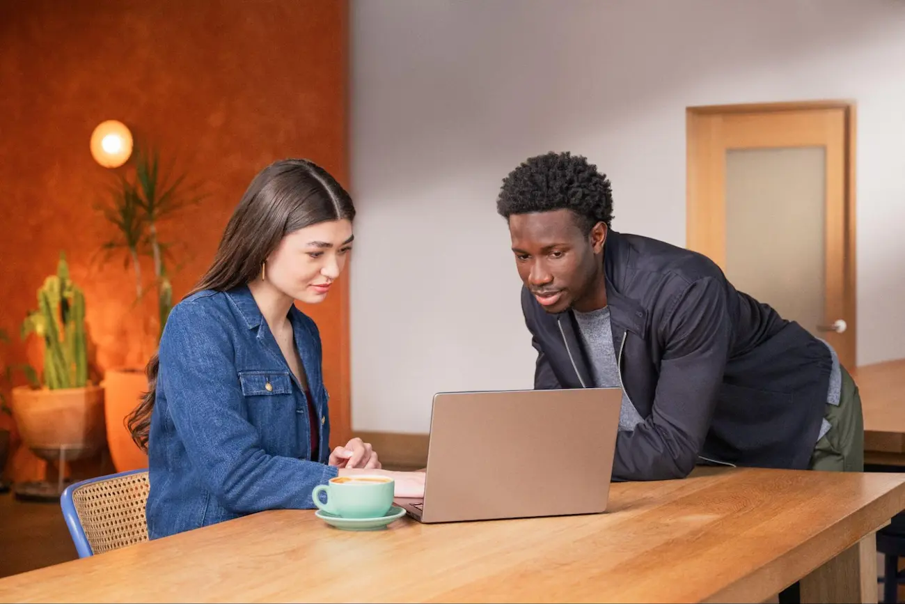 Man and Woman Looking At Laptop Screen