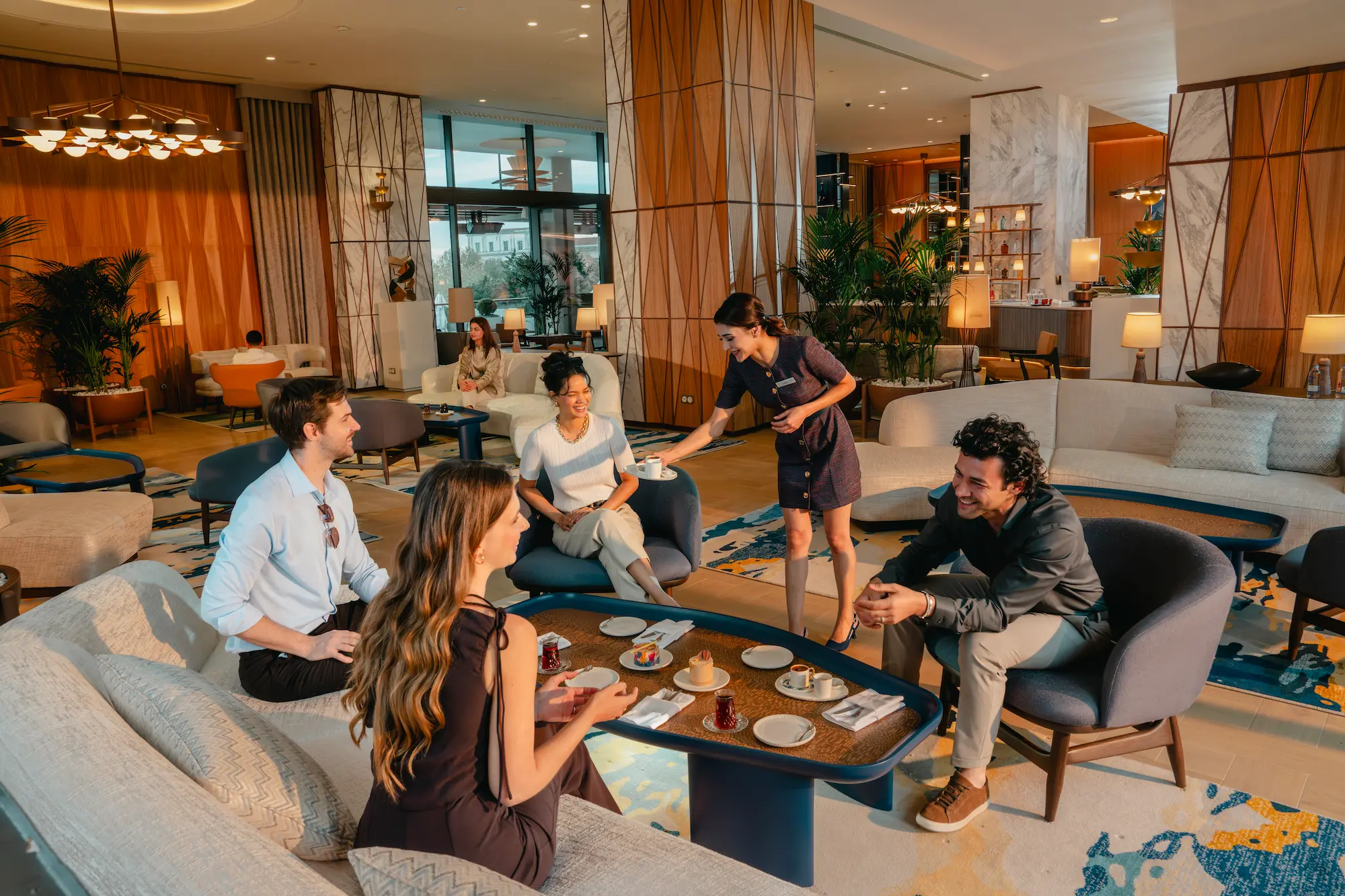 Hilton Hostess Serves Hotel Guests Meeting Over Breakfast